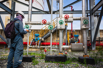 Male worker inspection at steel long pipes and pipe elbow in station oil factory during refinery valve