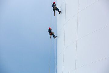 Male two workers down height tank rope access inspection of thickness shell plate storage tank gas propane