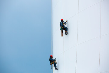 Male two workers down height tank rope access inspection of thickness shell plate storage tank gas propane