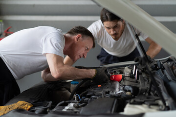 Fototapeta na wymiar Mechanic changing engine, service car workshop automobile. professional man shop maintenance