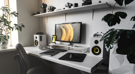 General view comfortable home office workplace of photographer with computer, camera lens in...
