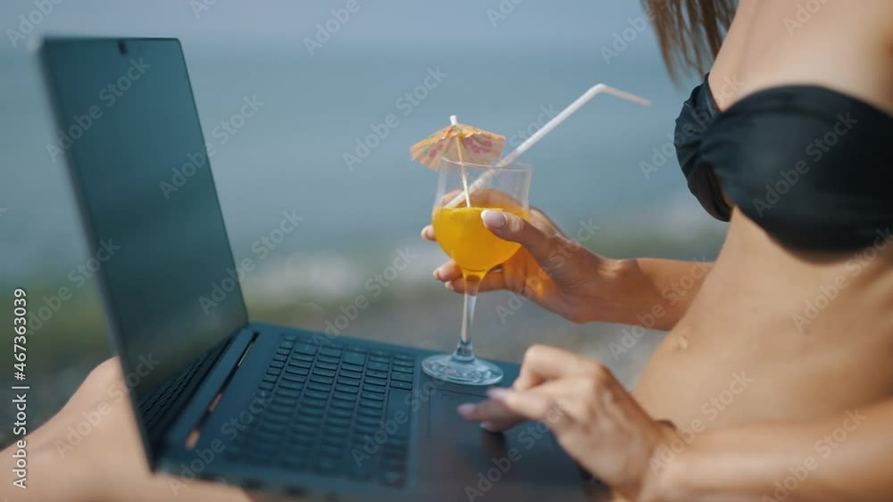 Poster a female freelancer is working on laptop near sea. programmer is coding and surfing on notebook. rem