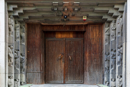 Оld wooden gate closed on a large barn castle. The old and mysterious wooden gate is closed to a large wooden castle