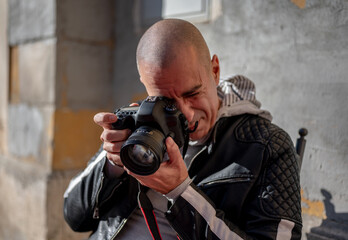 Naklejka na ściany i meble Photographer shooting with dslr camera