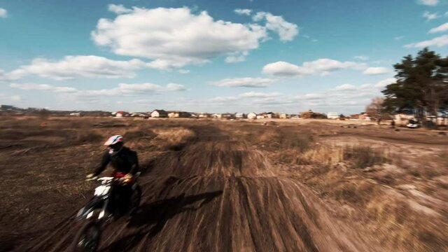 Motorcycles ride on gravel track, enduro competition
