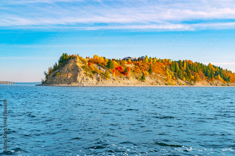 Wall mural autumn landscape, bright colorful leaves on the rocky riverbank. cape strelka at the confluence of t