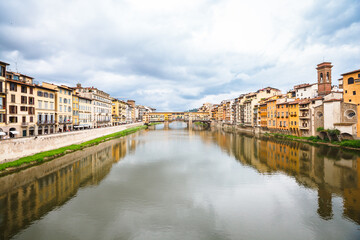 Fototapeta na wymiar huge crowds of people on the Ponte Vecchio, Florence, Italy. Spring cloudy day