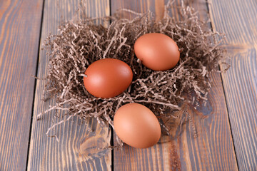 Brown chicken eggs on wooden background