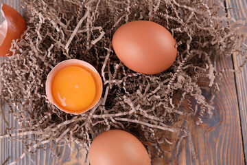 Brown chicken eggs on wooden background