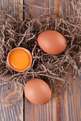 Brown chicken eggs on wooden background