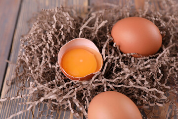 Brown chicken eggs on wooden background