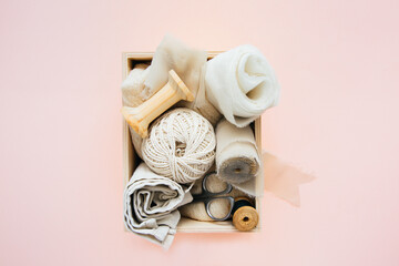 Box with accessories for sewing and needlework: threads, fabrics, scissors. Sewing and needlework concept.	