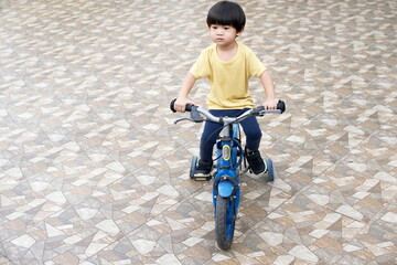 Little asian boy ridding bicycle