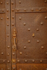 Old lock. Iron door with studs and lock.Rusted iron sheet of an ancient door. 