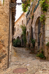 Fototapeta na wymiar deserted stone alley in tossa de mar on the spanish costa brava