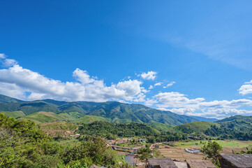 Fototapeta na wymiar Mountain landscape view and blue sky at nan province.Nan is a rural province in northern Thailand bordering Laos