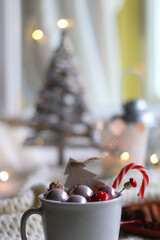 Various Christmas ornaments, candles and colorful bokeh lights. Selective focus.