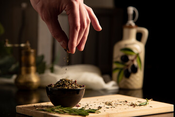 hand pouring spices