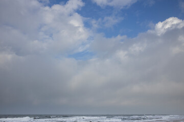 Fototapeta na wymiar Northsea coast Julianadorp Netherlands. Beach. Clouds. Waves.