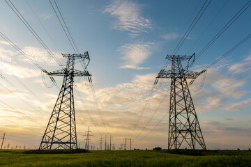 power line pylons at night with beautiful saturated sky.