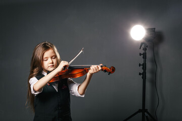 Young girl closeup studio portrait with violin