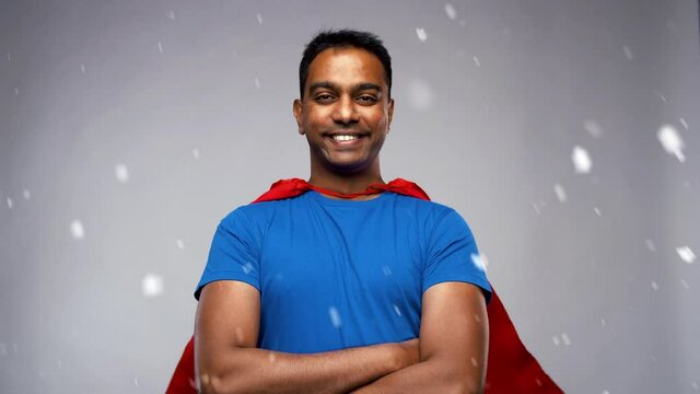 super power and people concept - happy smiling indian man in red superhero cape with crossed arms over grey background and snow
