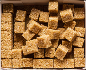 Brown sugar cubes in the paper package. Top view.
