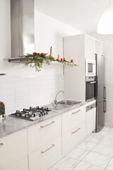 Modern white clean kitchen with Christmas decoration. Concept of interior of beautiful apartment.