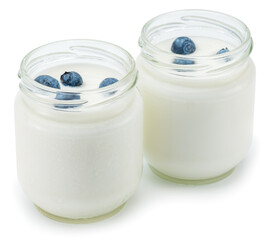 Two glass containers with plain yoghurt and berries isolated on white background.