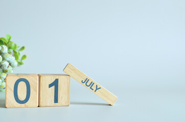 July 1, Calendar cover design with number cube with green fruit on blue background.