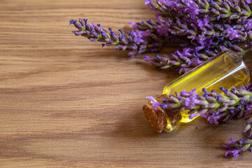 Obraz na płótnie Canvas Lavender essential oil in a small bottle. Selective focus.