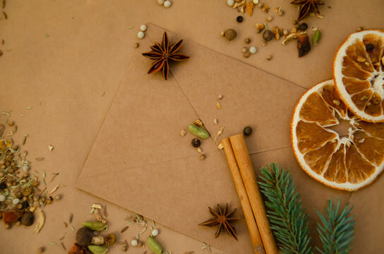 Christmas and New Year's background with copy space. Vintage envelope with letter lying on table with star anise, spruce branch, dried orange, spices, cinnamon stick.
