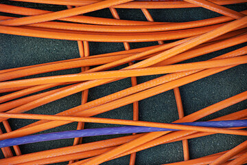 Many colored power cables lie on top of each other.