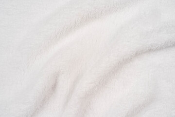 Blurred background of soft light tissue. Beige background of plush fabric