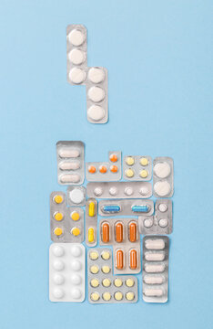 Tetris Game From Medical Pills, Top View On Blue Background. Health Care Concept As A Challenge Or Quest. Treatment Blisters Of Tablets In Shape Of Block Game. Healthcare Pharmaceutical Background