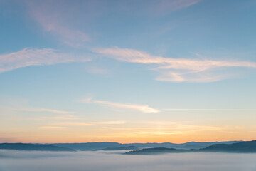 Fototapeta na wymiar view of sunrise above mountains mist in the bottom