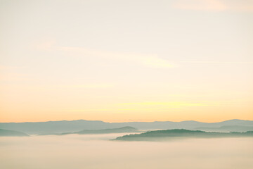 view of sunrise above mountains mist in the bottom