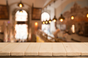 Empty dark wooden table in front of abstract blurred bokeh background of restaurant . can be used for display or montage your products.Mock up for space