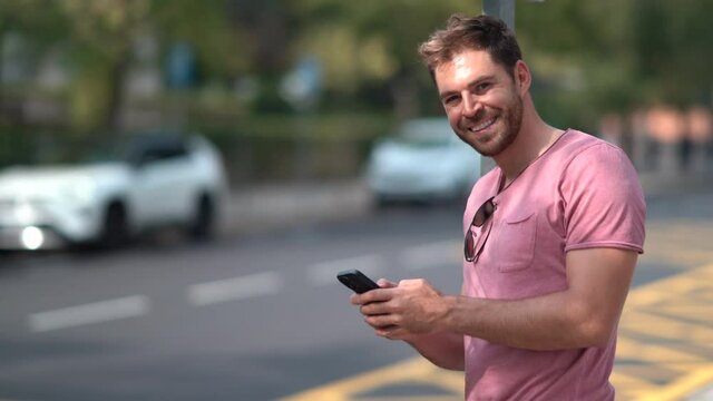 Close-up man's hands using a cell phone in the city