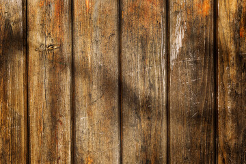 The surface of an old wooden wall made of vertical planks. Construction and repair. Background. Space for text.