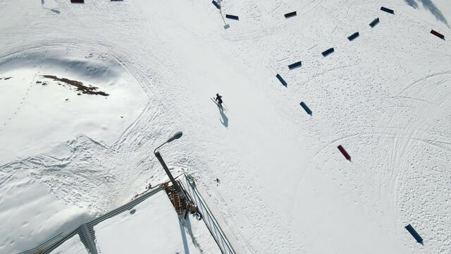 Aerial Top view of a participant in a biathlon race. Athlete overcomes the distance on skis.
