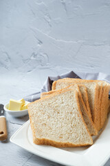 Whole wheat sandwich bread in white plate with white background