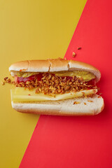 Hot Dog with mustard and ketchup over yellow background