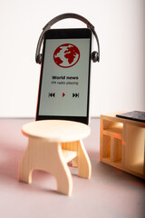 Studio shot of a modern smartphone wearing headphones and listening media.