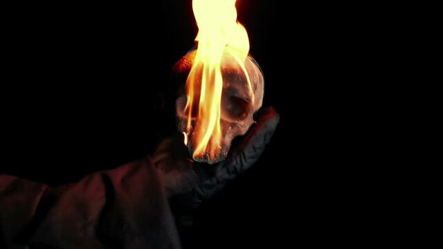 Flaming Skull Is Held Up And Flies Into Camera