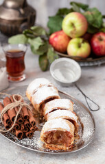 Traditional apple strudel with cinnamon and powdered sugar