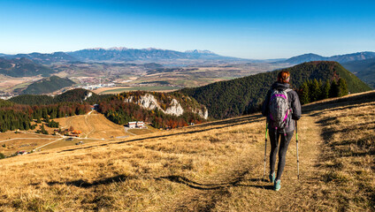 Fototapeta na wymiar Hiking girl walking in path in colorful autumn forest at Cutkovska valley, Slovakia