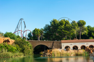 view of shambhala roller coaster over lake portaventura, park, of attractions in tarragona,...