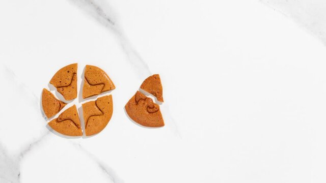 Dalgona candy on a white background move and fall into pieces - Stop Motion Animation