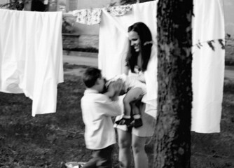 happy family making laundry outside, children helping